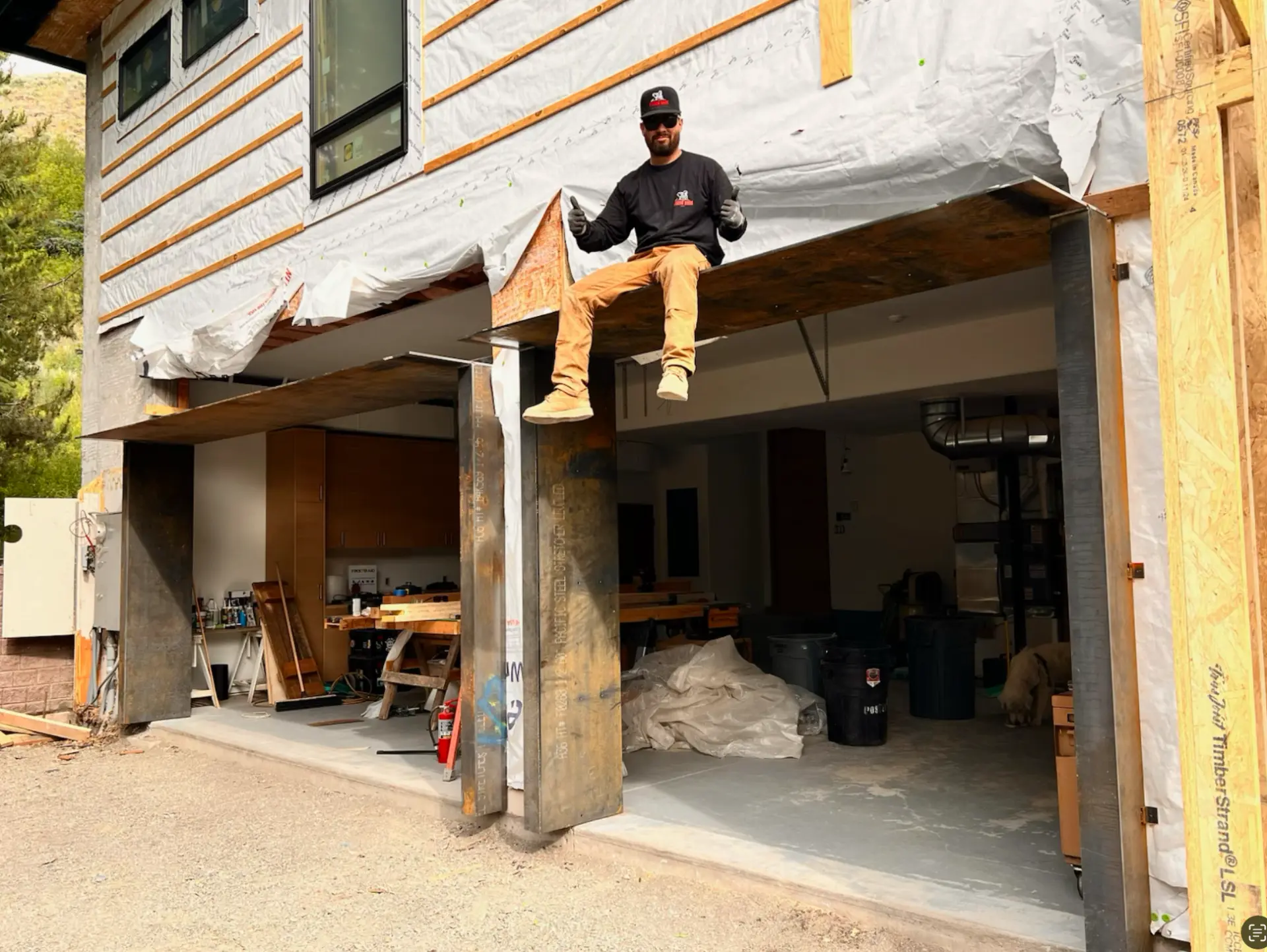 Fusion Bros owner Pilo seated on a welded steel structure at a residential jobsite in Ketchum, Idaho