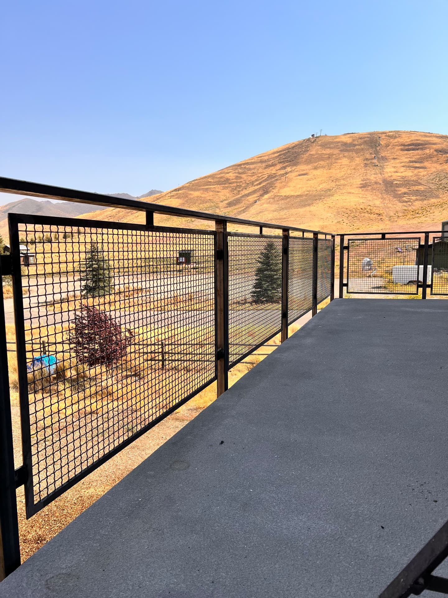 Custom black steel mesh deck railing overlooking the hills near Ketchum, Idaho