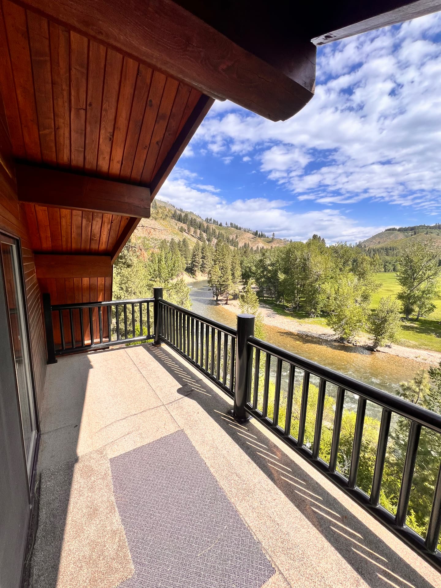 Black steel balcony railing overlooking a wooded mountain landscape near Ketchum, Idaho
